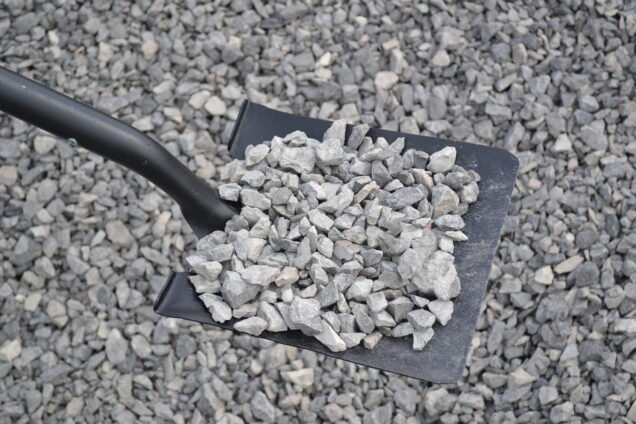 Square point shovel lifting rocks